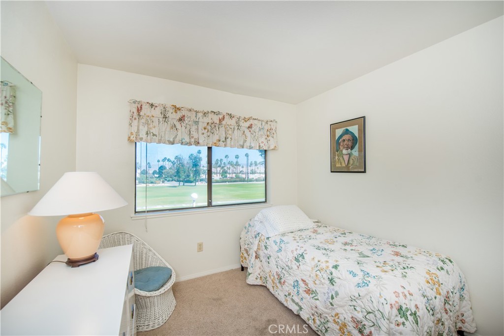 6087 Montecito Circle, Unit 4 Palm Springs, CA 92264 - Photo 23 of 45 a bedroom with a bed and a window