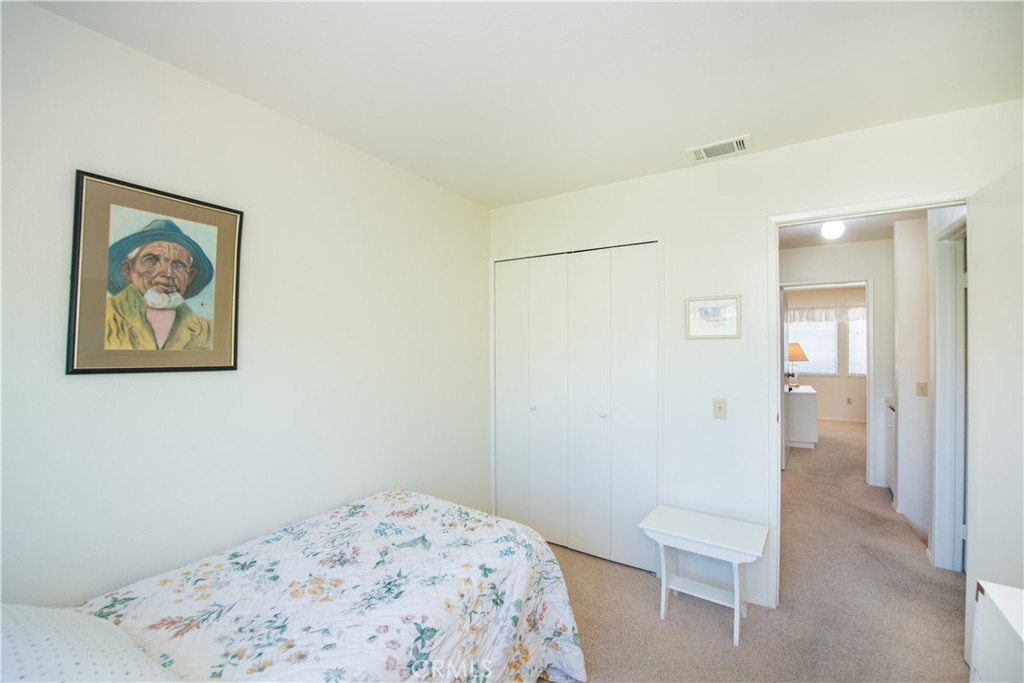 6087 Montecito Circle, Unit 4 Palm Springs, CA 92264 - Photo 24 of 45 a bedroom with a bed and bathroom