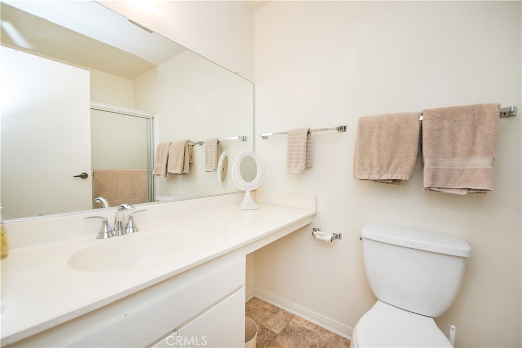 6087 Montecito Circle, Unit 4 Palm Springs, CA 92264 - Photo 25 of 45 a bathroom with a sink toilet and mirror