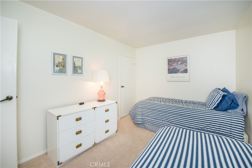 6087 Montecito Circle, Unit 4 Palm Springs, CA 92264 - Photo 27 of 45 a bedroom with a bed and a cabinets