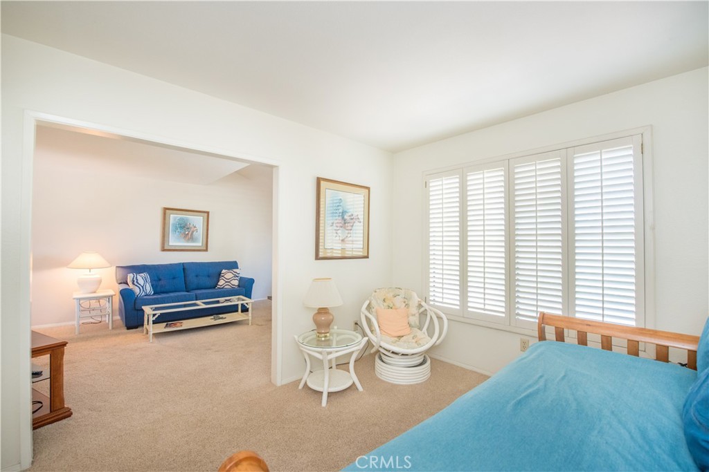 6087 Montecito Circle, Unit 4 Palm Springs, CA 92264 - Photo 6 of 45 a living room with furniture and a window