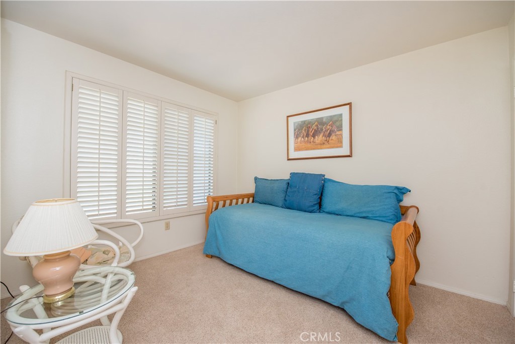 6087 Montecito Circle, Unit 4 Palm Springs, CA 92264 - Photo 7 of 45 a living room with furniture and a window