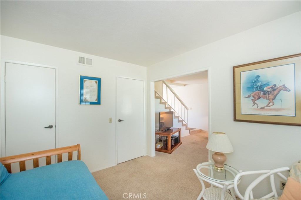 6087 Montecito Circle, Unit 4 Palm Springs, CA 92264 - Photo 8 of 45 a bedroom with furniture and a rug