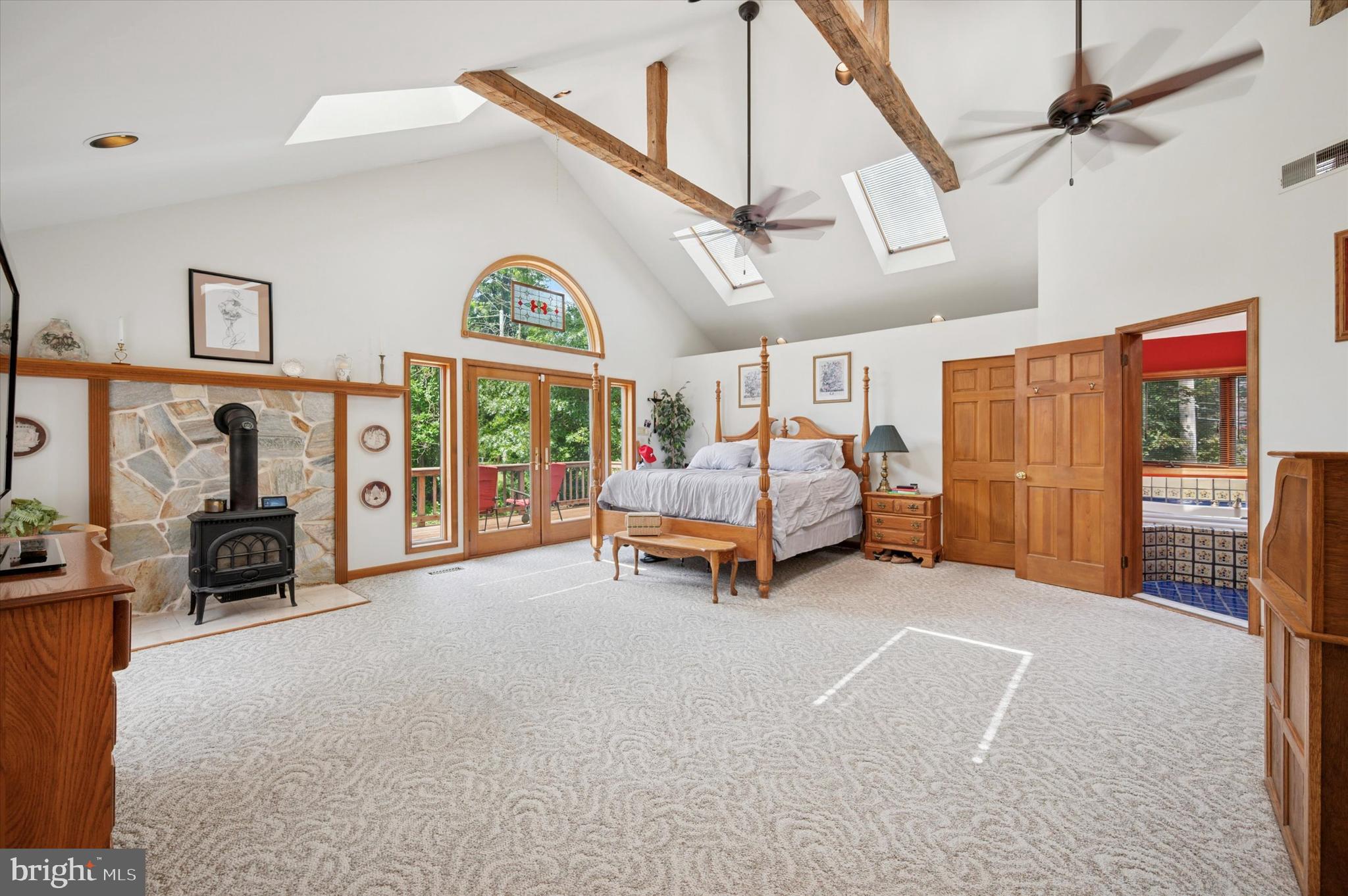 2440 Walton Road Huntingdon Valley, PA 19006 - Photo 24 of 47 a spacious bedroom with a bed and a chandelier