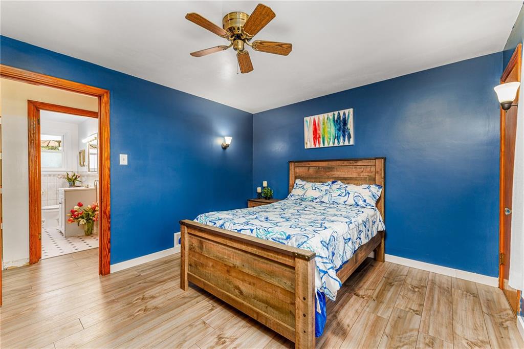 2676 Ridge Rd Extension Baden, PA 15005 - Photo 11 of 35 a room with a bed and a chandelier