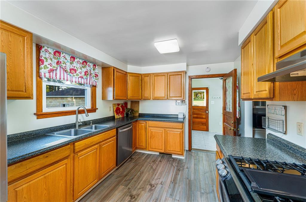 2676 Ridge Rd Extension Baden, PA 15005 - Photo 31 of 35 a kitchen with stainless steel appliances granite countertop a sink stove and cabinets