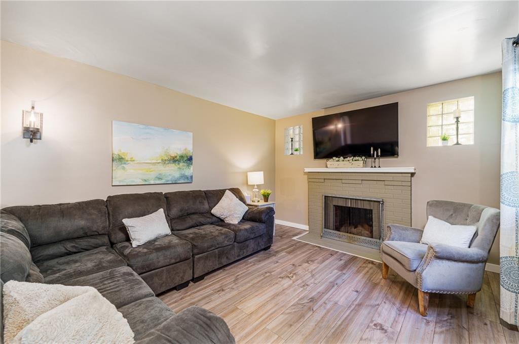 2676 Ridge Rd Extension Baden, PA 15005 - Photo 4 of 35 a living room with furniture a fireplace and a flat screen tv
