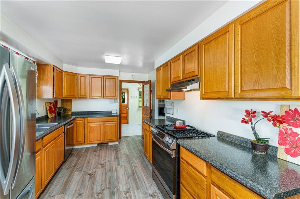 2676 Ridge Rd Extension Baden, PA 15005 - Photo 8 of 35 a kitchen with stainless steel appliances granite countertop a sink stove and refrigerator