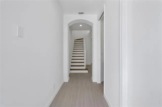 a view of a kitchen with refrigerator and microwave