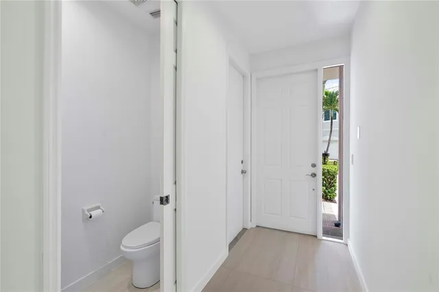 a kitchen with stainless steel appliances granite countertop a stove top oven a sink and a refrigerator with wooden floor