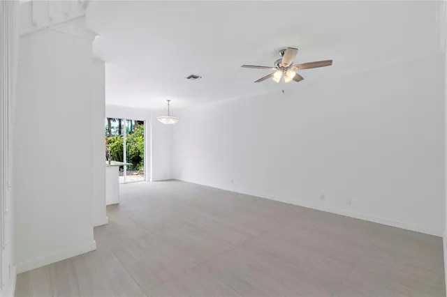 a bathroom with a large window sink and cabinets