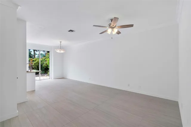 a view of a kitchen with furniture and chandelier fan