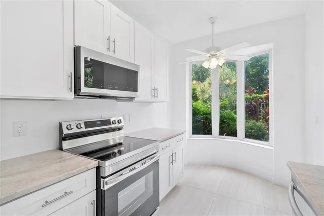 an empty room with window and ceiling fan