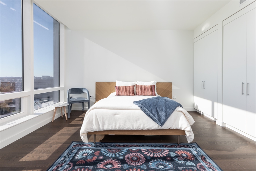 40 Trinity Place, Unit 1606 Boston, MA 02116 - Photo 2 of 13 a bedroom with a bed and wooden floor