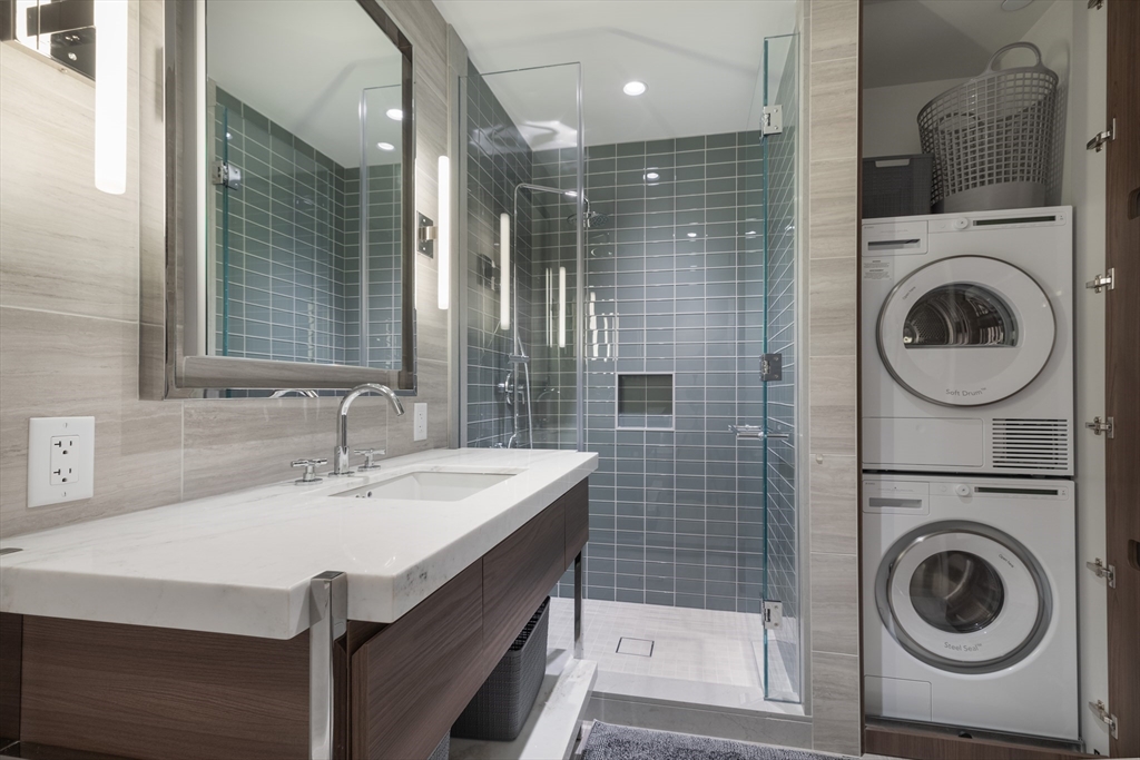 40 Trinity Place, Unit 1606 Boston, MA 02116 - Photo 4 of 13 a bathroom with a sink a toilet and a mirror