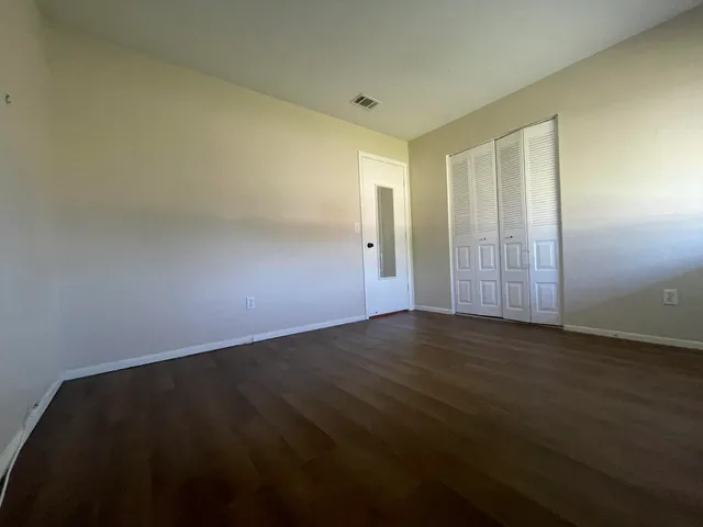 an empty room with wooden floor