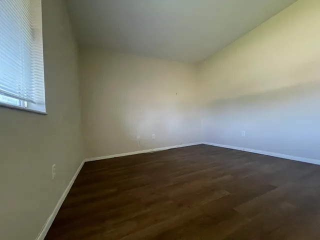 an empty room with wooden floor