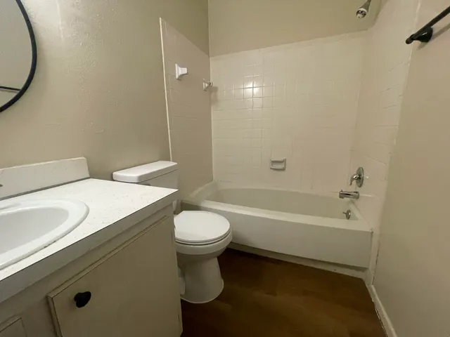 a bathroom with a sink a toilet and a bathtub