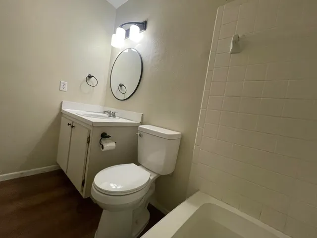 a bathroom with a toilet sink and mirror