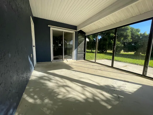 a view of a house with porch and a garden