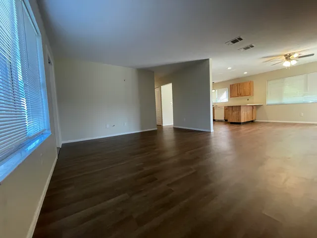 a view of a room with wooden floor and window