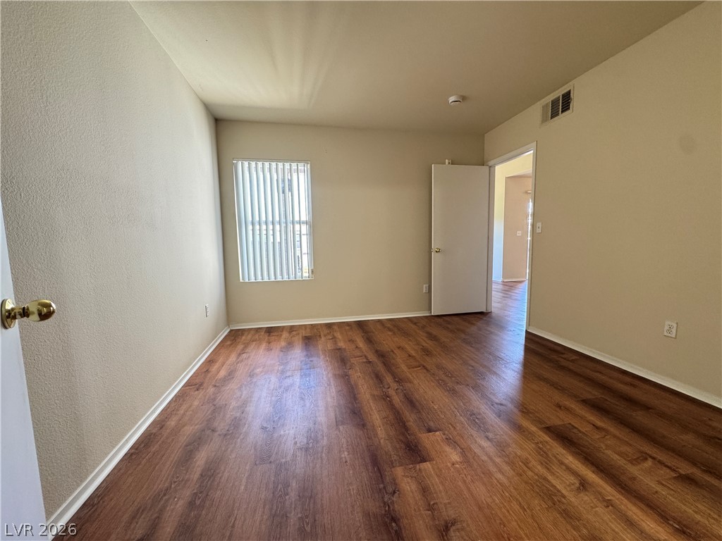 7255 West Sunset Road, Unit 2111 Las Vegas, NV 89113 - Photo 18 of 33 Rich hardwood-style flooring extends through this airy bedroom, offering a clean, adaptable space.