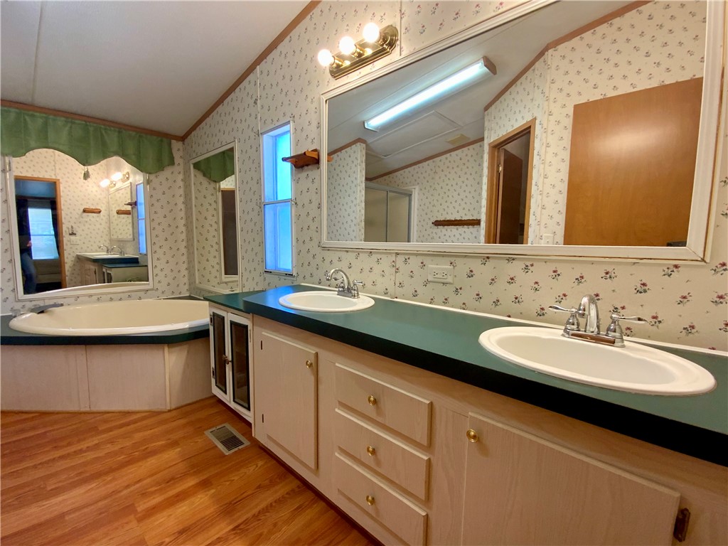 631 Masaw Lane Seneca, SC 29672 - Photo 16 of 32 This bathroom features a double vanity with ample storage and a luxurious soaking tub.