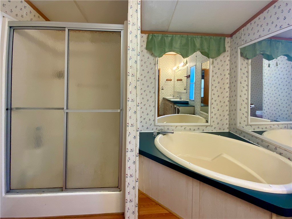 631 Masaw Lane Seneca, SC 29672 - Photo 18 of 32 This bathroom features a soaking tub and a shower stall.