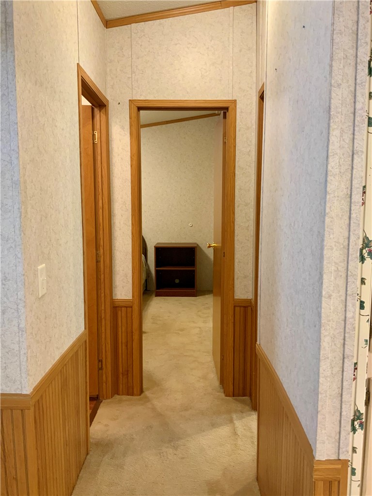 631 Masaw Lane Seneca, SC 29672 - Photo 20 of 32 This interior hallway features warm wooden trim and soft carpeting, creating a cozy and inviting atmosphere.