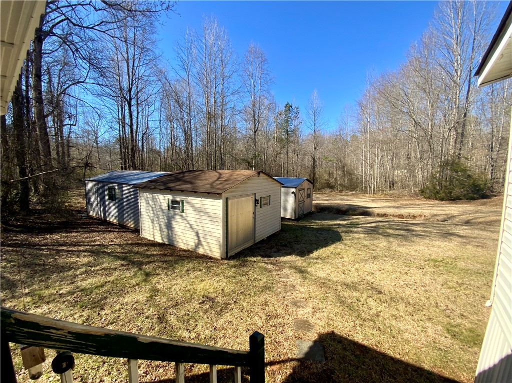 631 Masaw Lane Seneca, SC 29672 - Photo 27 of 32 This spacious yard features multiple sheds, offering ample outdoor storage for any need.