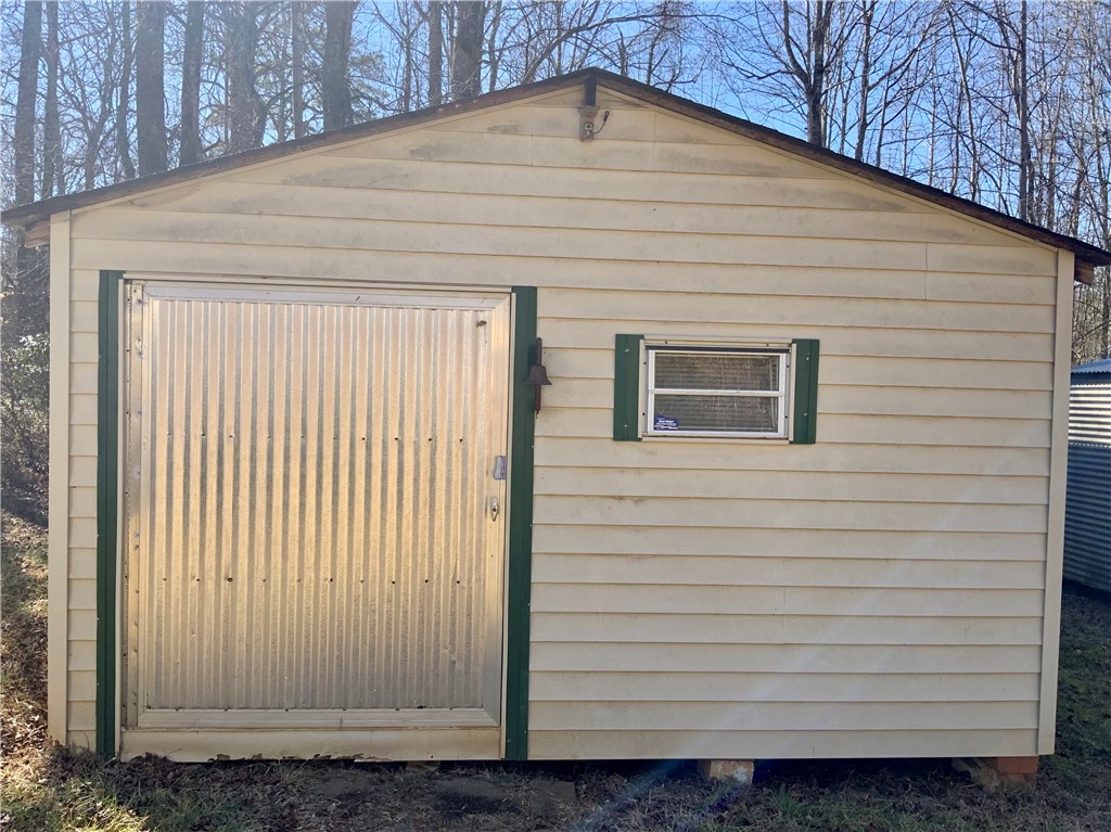 631 Masaw Lane Seneca, SC 29672 - Photo 28 of 32 This charming shed offers practical outdoor storage amidst a serene natural backdrop.