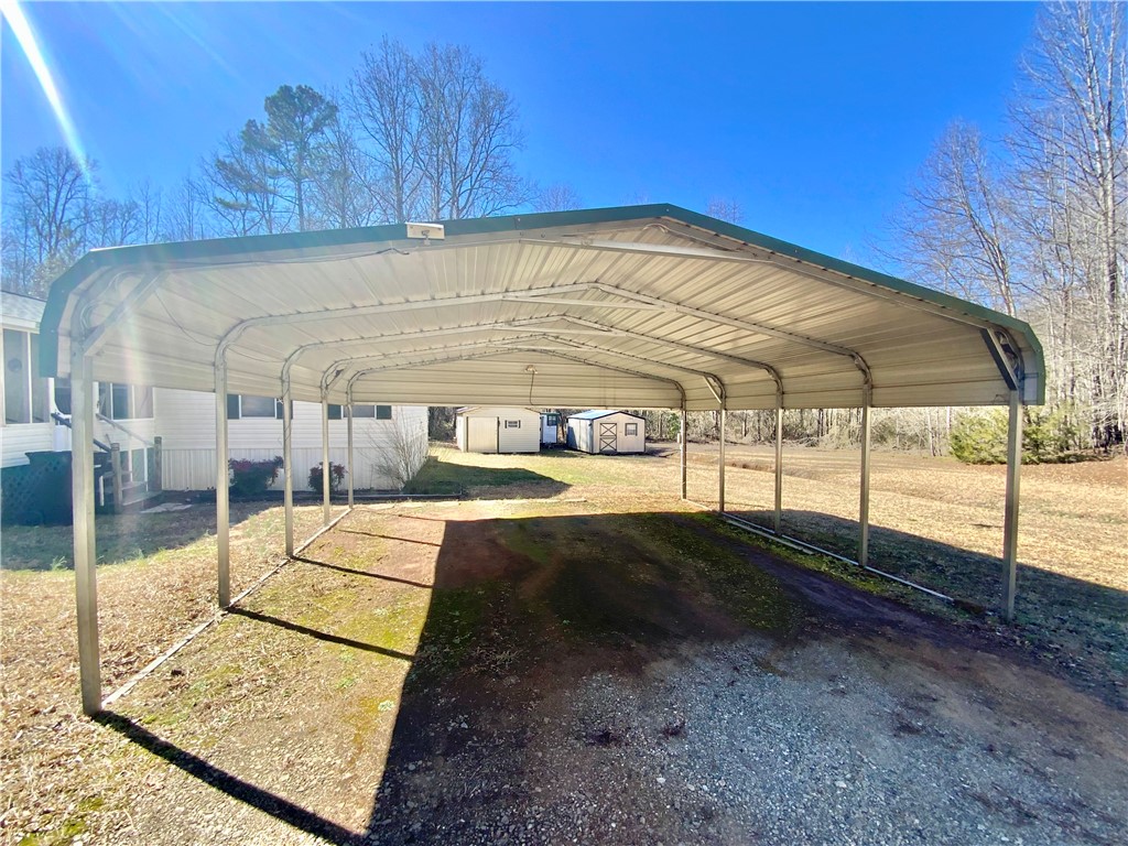 631 Masaw Lane Seneca, SC 29672 - Photo 32 of 32 This spacious carport provides ample covered parking, with additional storage in the background.