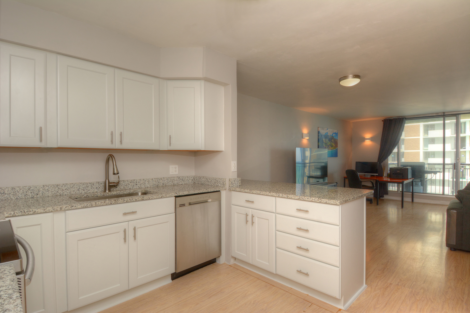6007 North Sheridan Road, Unit 23D Chicago, IL 60660 - Photo 7 of 22 a kitchen with white cabinets and sink