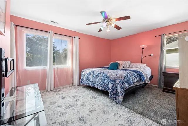 a bedroom with a large bed and a window