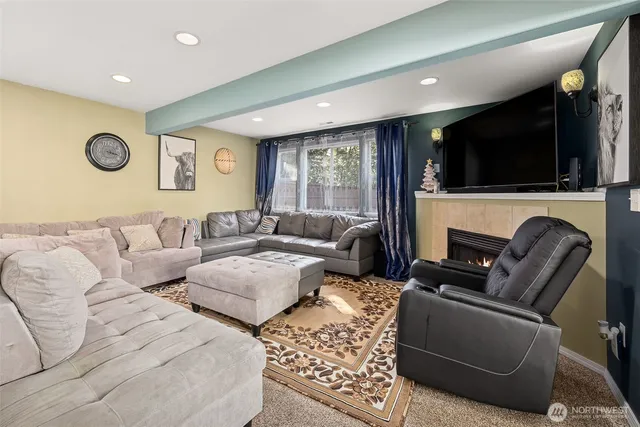 a living room with furniture fireplace and flat screen tv
