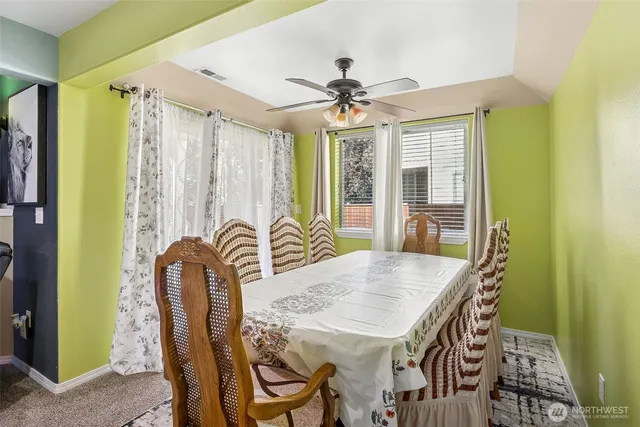 a view of a a dining room with furniture window and wooden floor