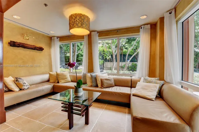 a living room with furniture and a large window