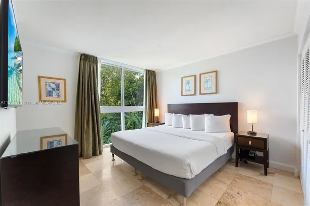 a bedroom with a large bed and a view of bedroom