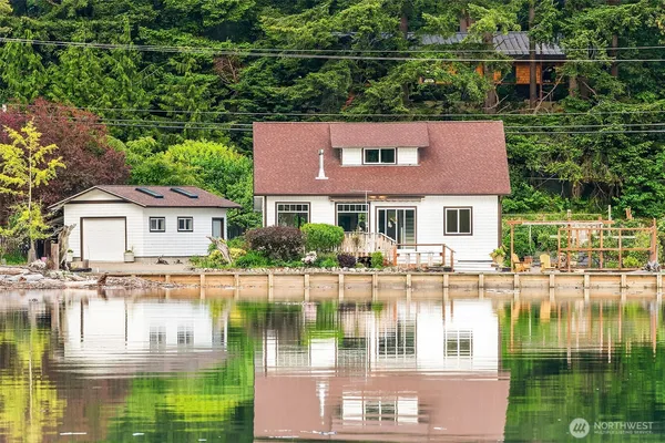 a front view of a house with a lake view