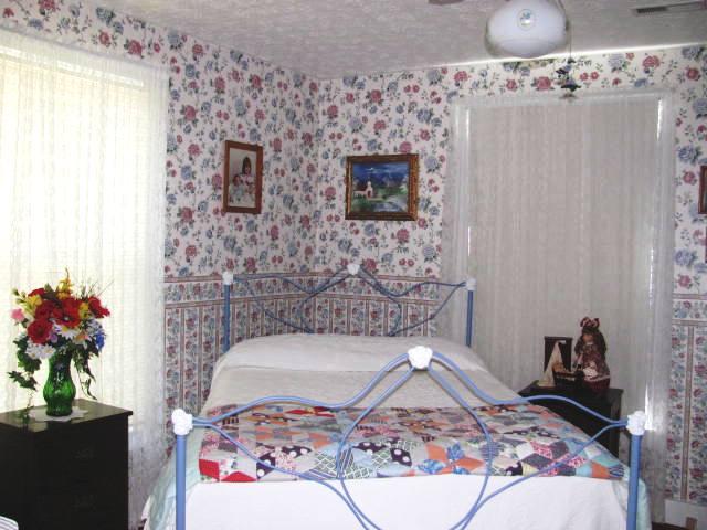 105 Adams Loop Tennessee Ridge, TN 37178 - Photo 6 of 20 a bedroom with a bed and a mirror