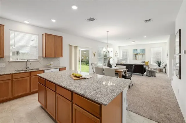 a large kitchen with lots of counter space sink and cabinets