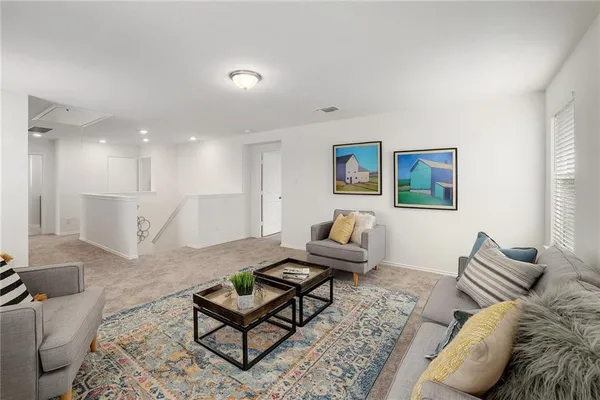 a living room with furniture and a rug