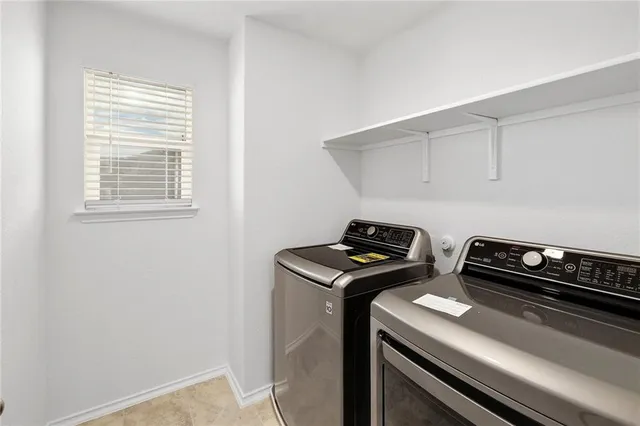 a view of storage and utility room with washer and dryer