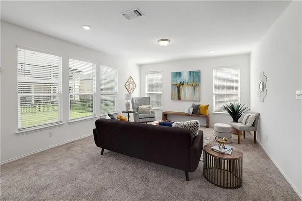a living room with furniture and a large window