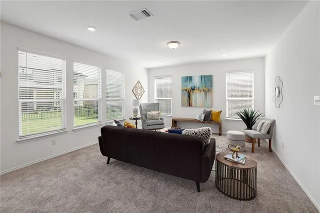 a living room with furniture and a large window