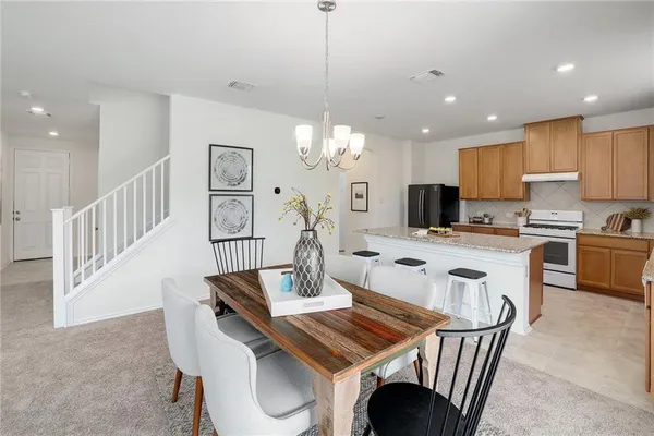a view of kitchen with dining table and chairs
