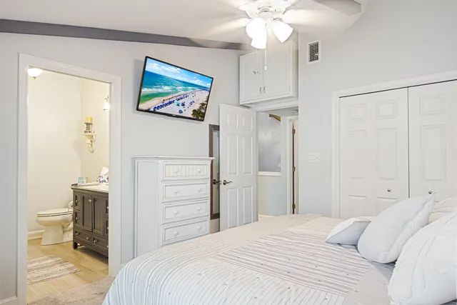 a bathroom with a granite countertop sink mirror vanity and toilet