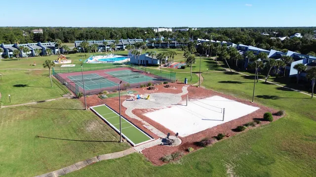 a living room with furniture a wooden floor and next to a window