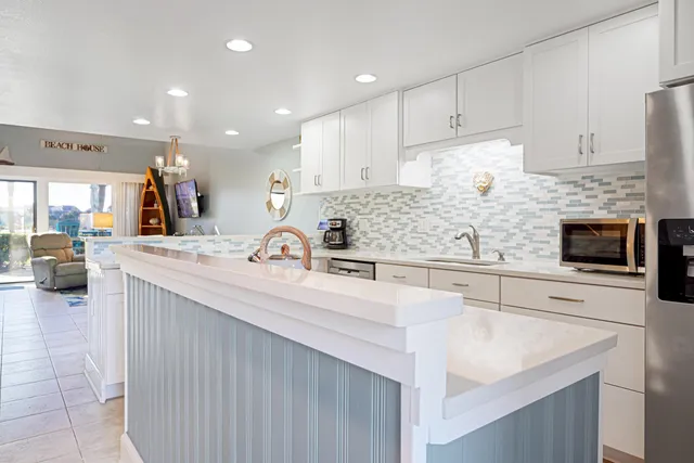 a kitchen with a sink stove and cabinets