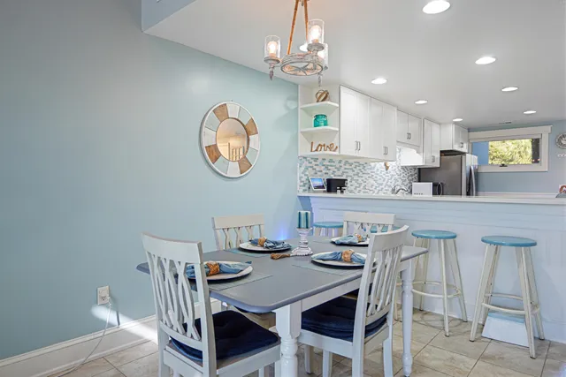 a view of a dining room with furniture and chandelier